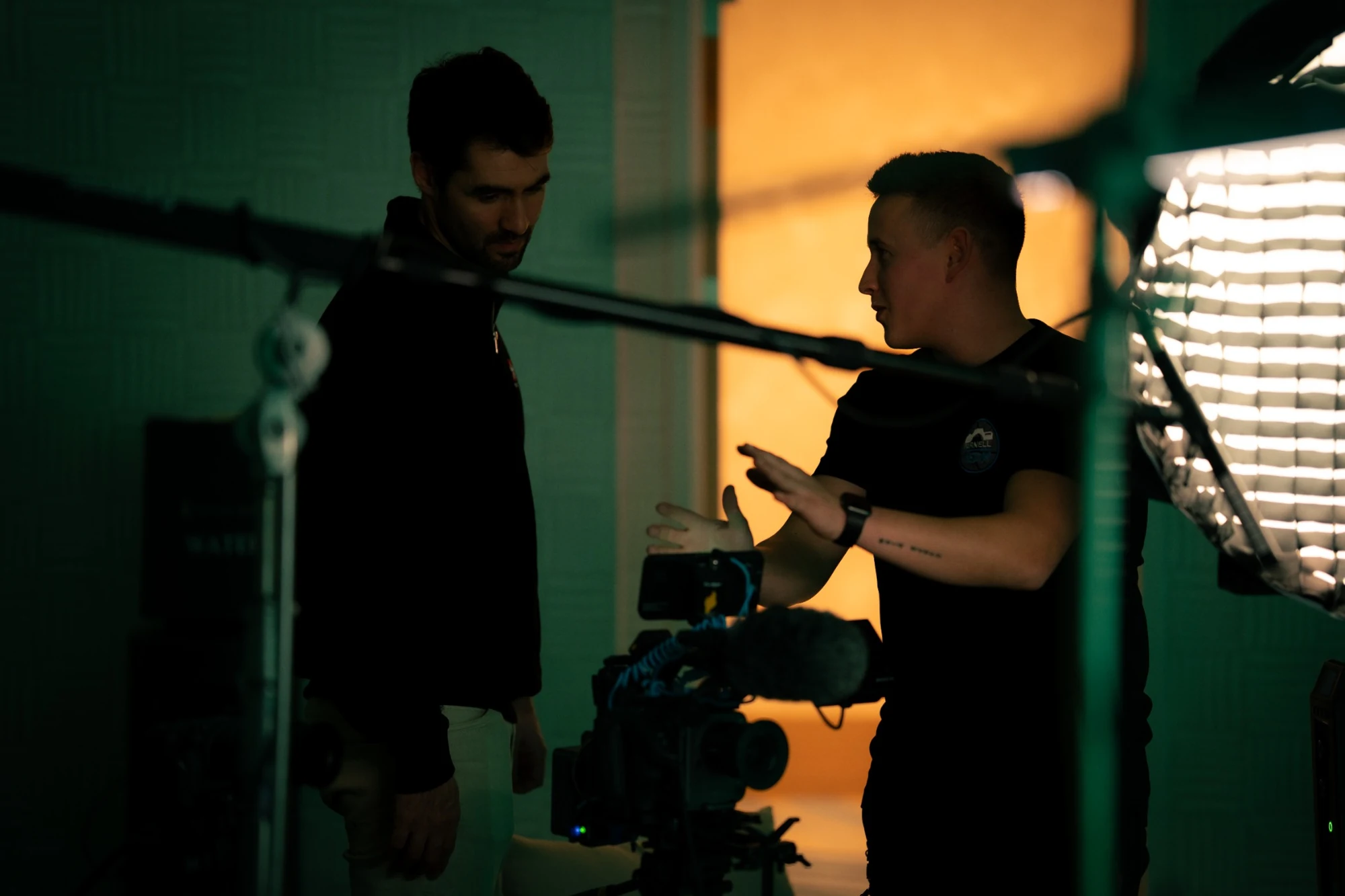 Production crew preparing a camera, boom microphone and lighting for an interview