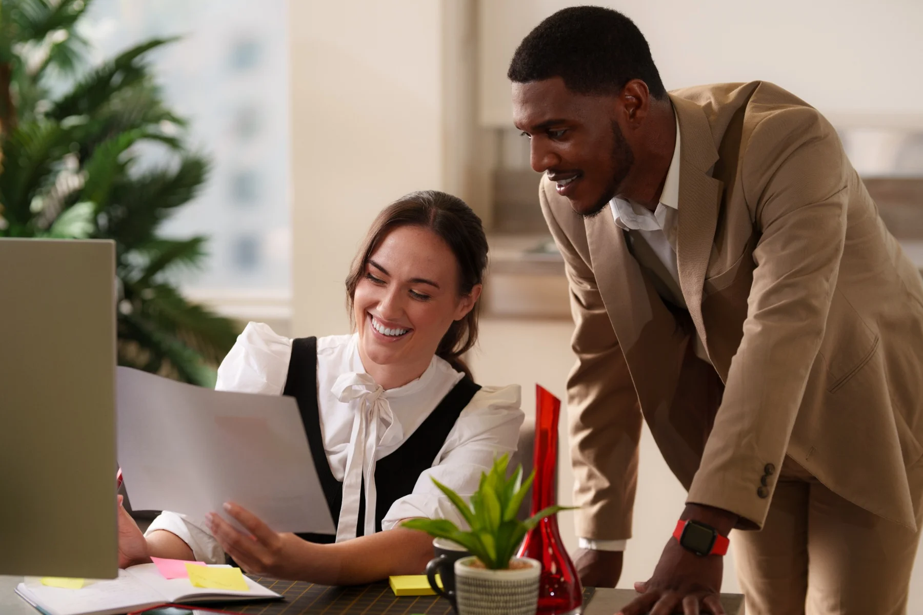 Two colleagues collaborating at a desk during the Revizto styled brand shoot