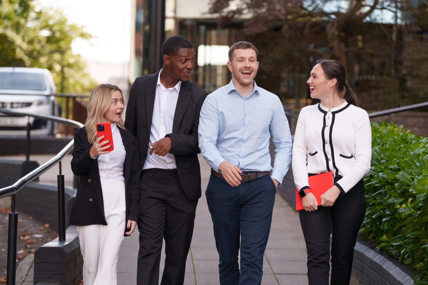 Four colleagues walking together outside during the Revizto brand shoot