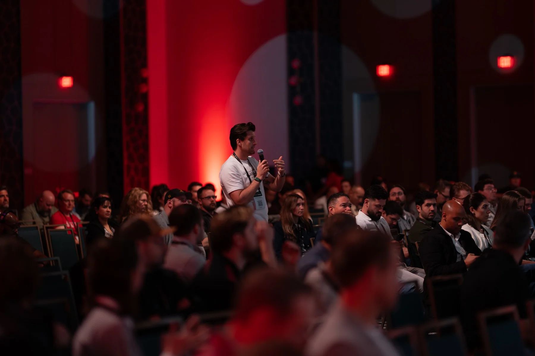 An attendee asking a question during a conference session