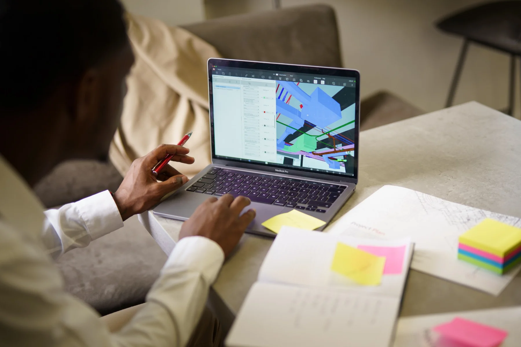 Revizto software in use on a laptop, with notes and project materials